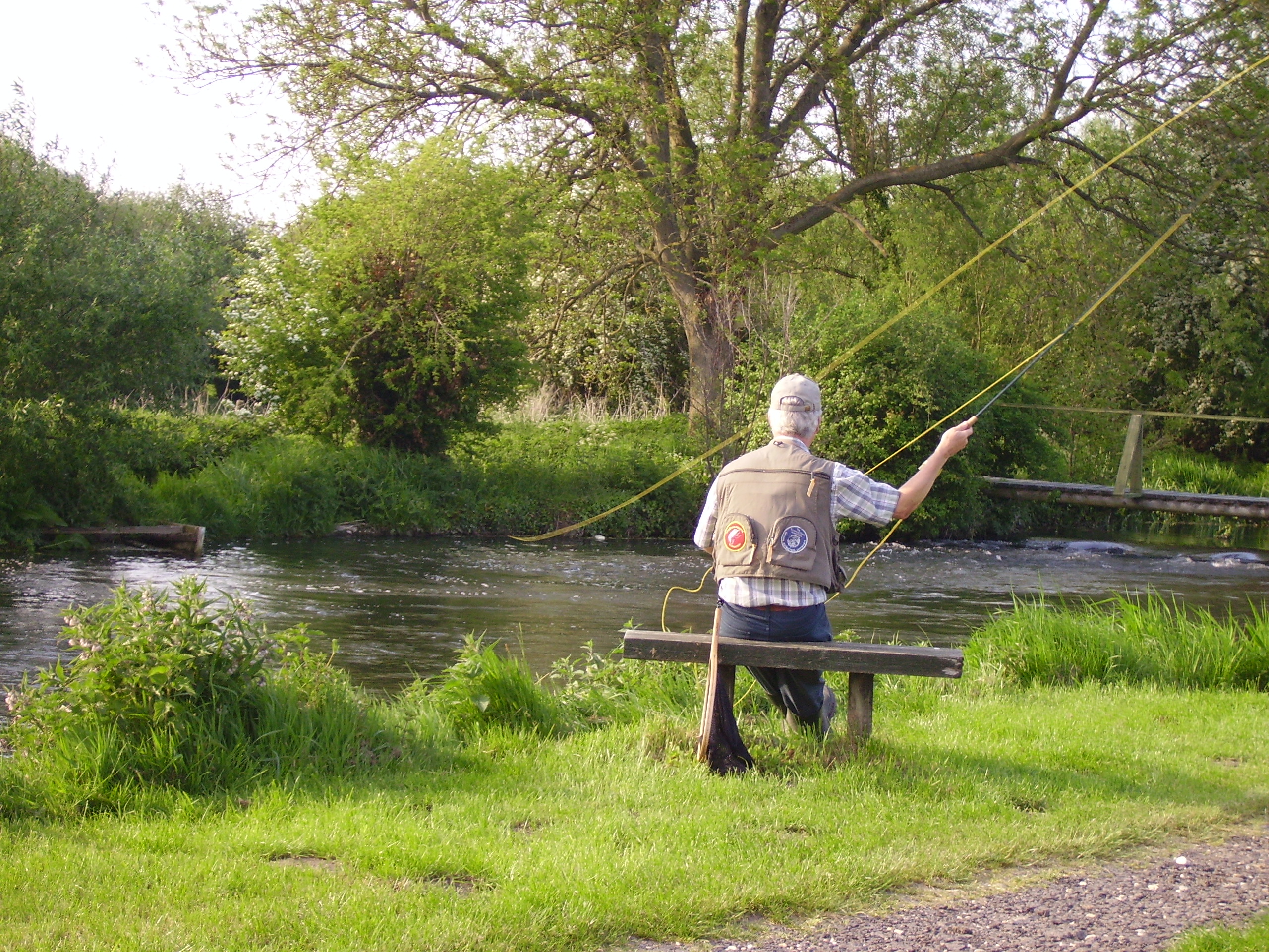 Man fishing from bench